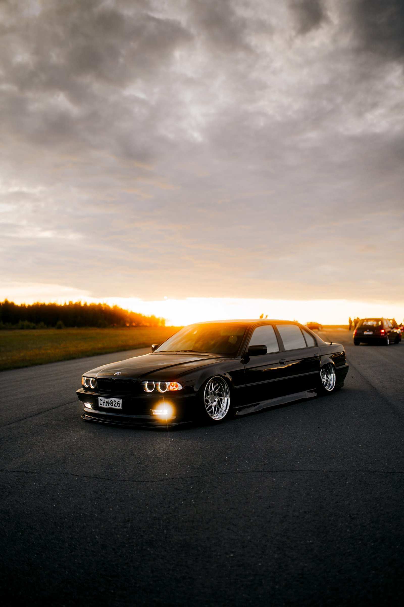 Black BMW 3 Series E36 with glowing angel-eye headlights at sunset &ndash; Wicked Street Customs
