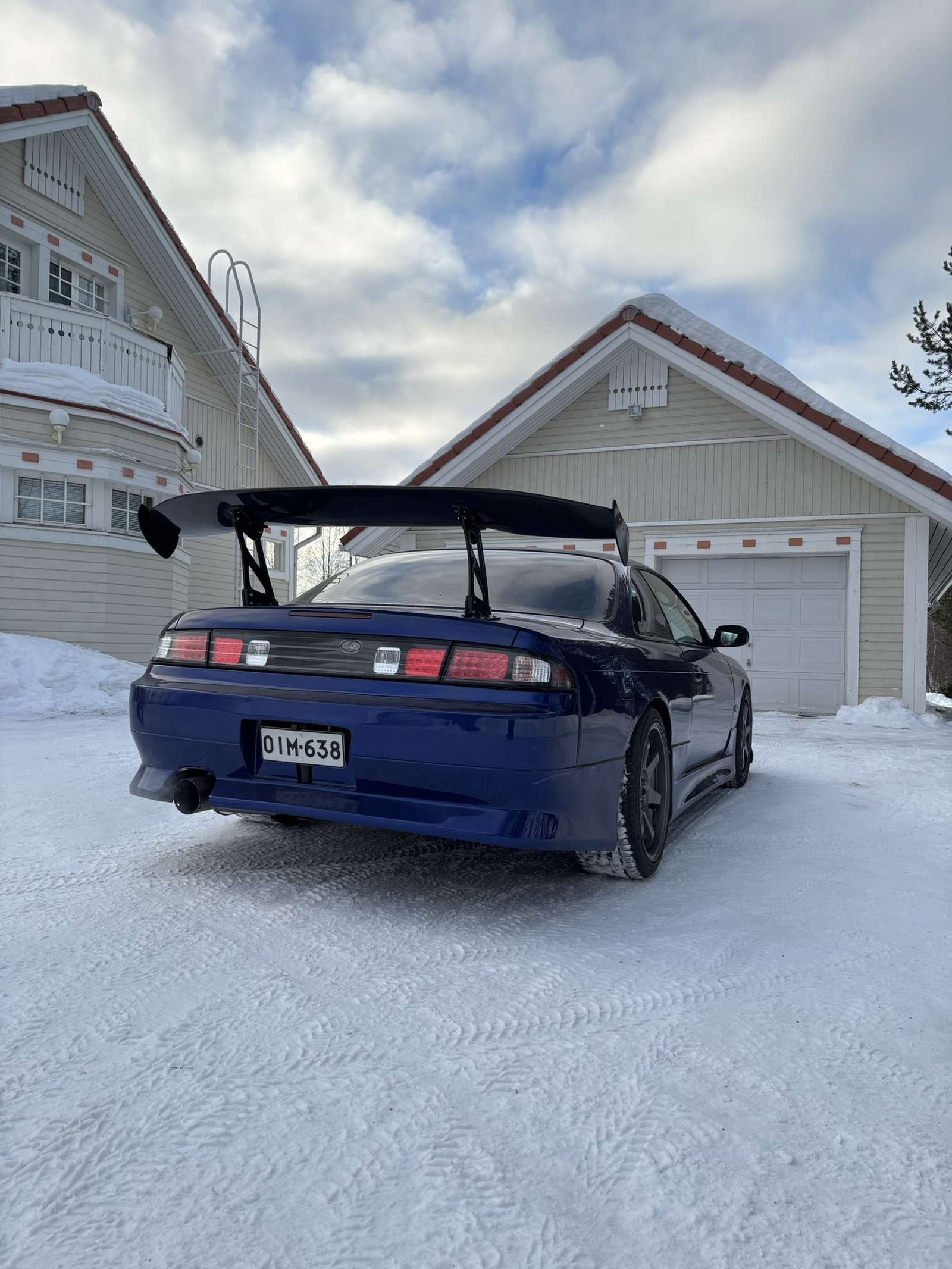 Blue Nissan Silvia S14 with a rear wing in the snow &ndash; Wicked Street Customs
